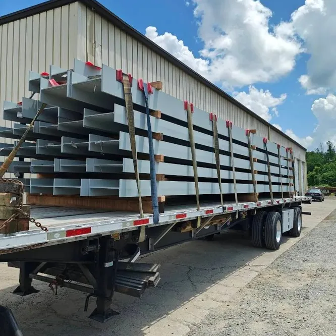 Flatbed loaded with steel beams, side view